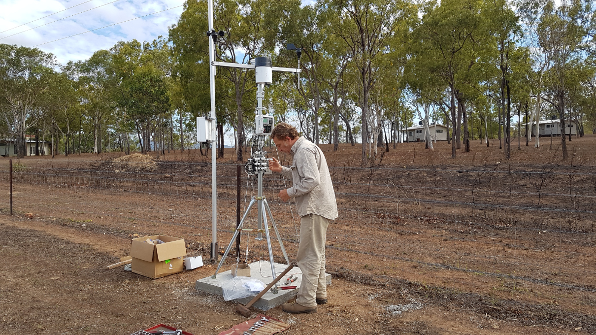Michael Goddard installing a weather station near Laura
